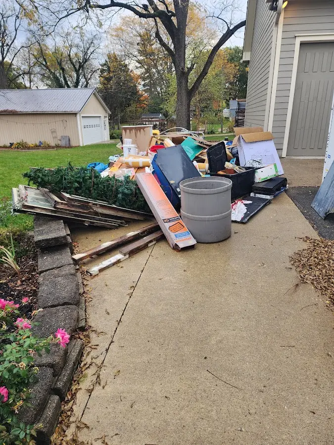 Dumpster being loaded with debris for Estate Cleanout Dumpster Rental in Lansford